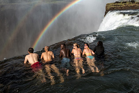 swimming in the devil's pool in victoria falls zambia African safari Holiday